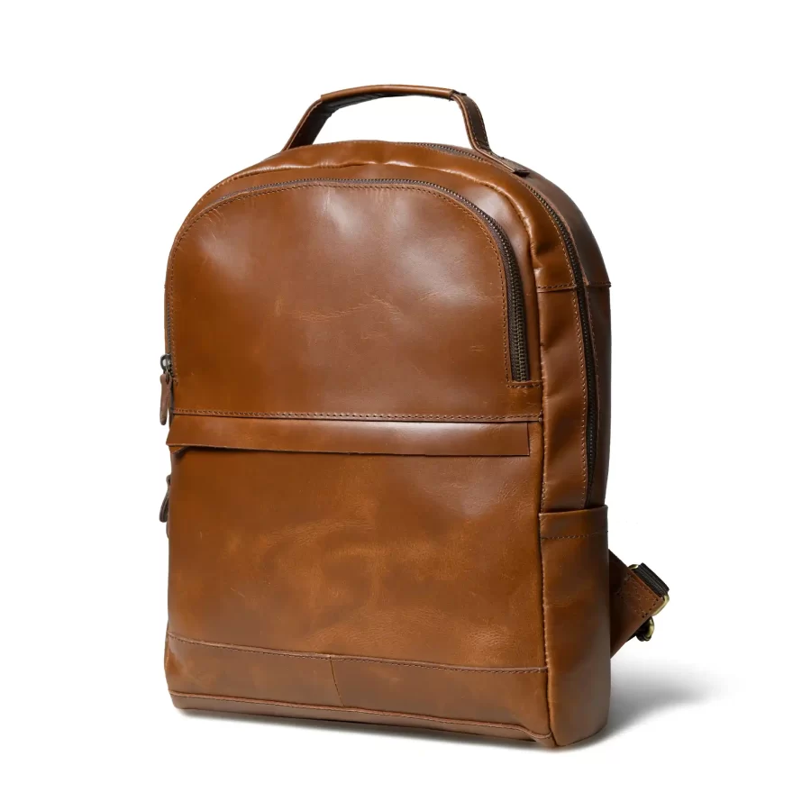 Side view of a tan brown leather backpack with 3 chains