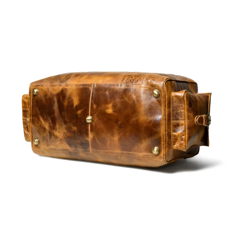 Bottom side view of a tan brown duffle bag with pockets