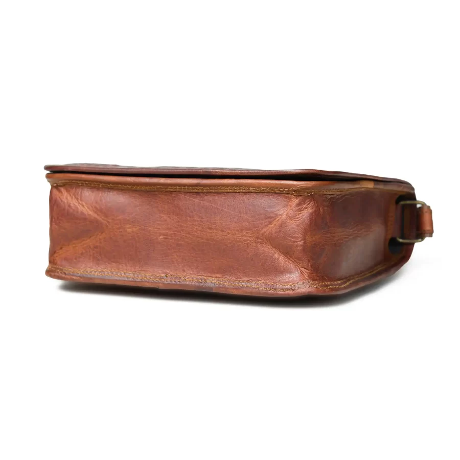 Bottom side view of a brown full flap sling bag in square shape 4