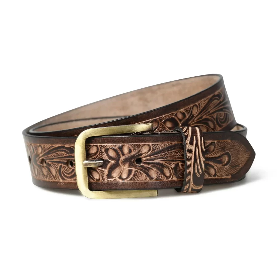 Close-up of dark brown leather belt with floral design.