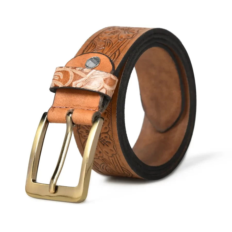 Tan brown leather belt rolled up with buckle.