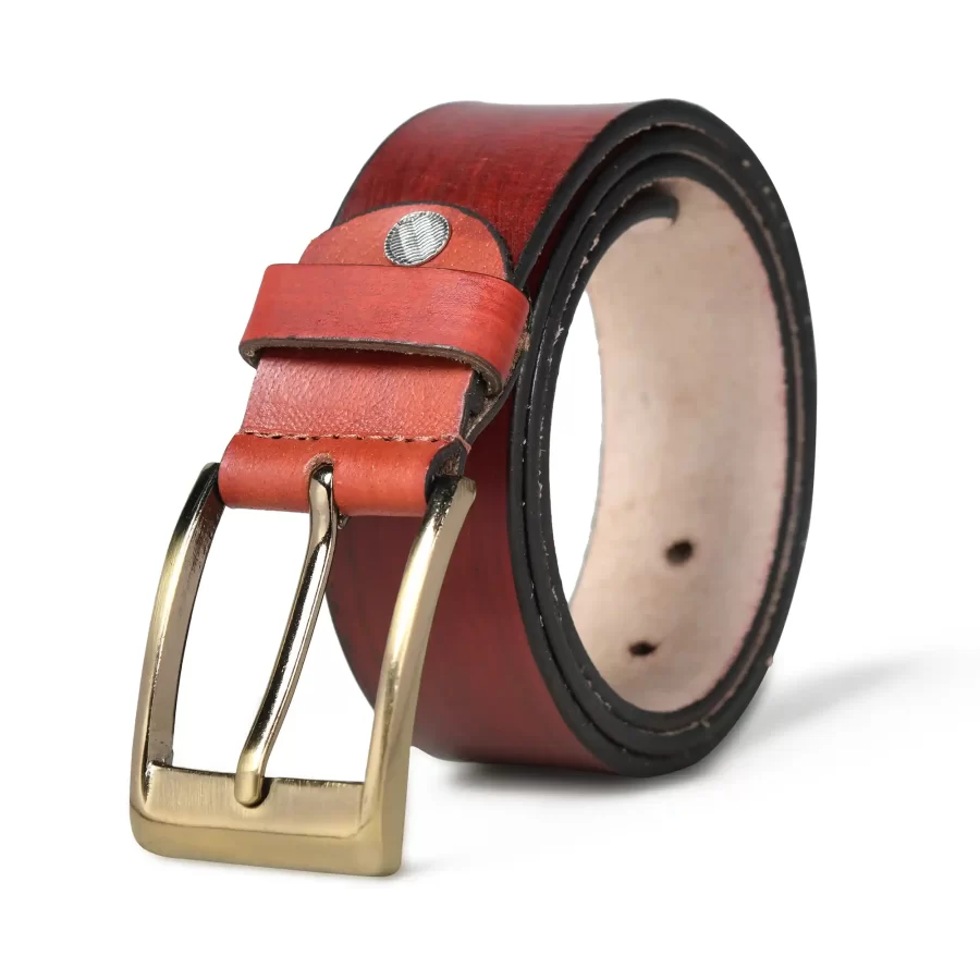 Burnt umber leather belt rolled up with buckle.