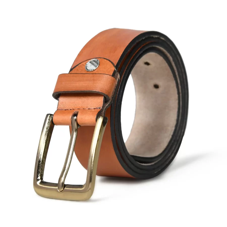 Tan brown leather belt rolled up with buckle.