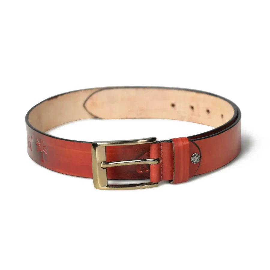 Full view of rusty red leather belt laid flat.