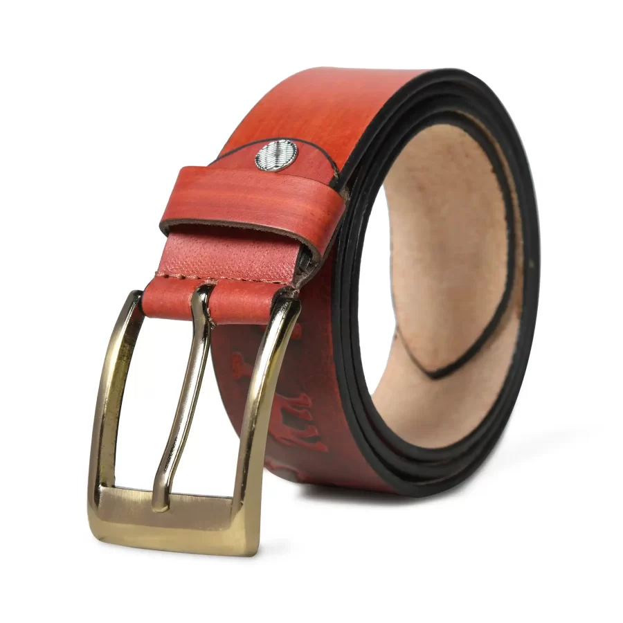 Rusty red leather belt rolled up with buckle.