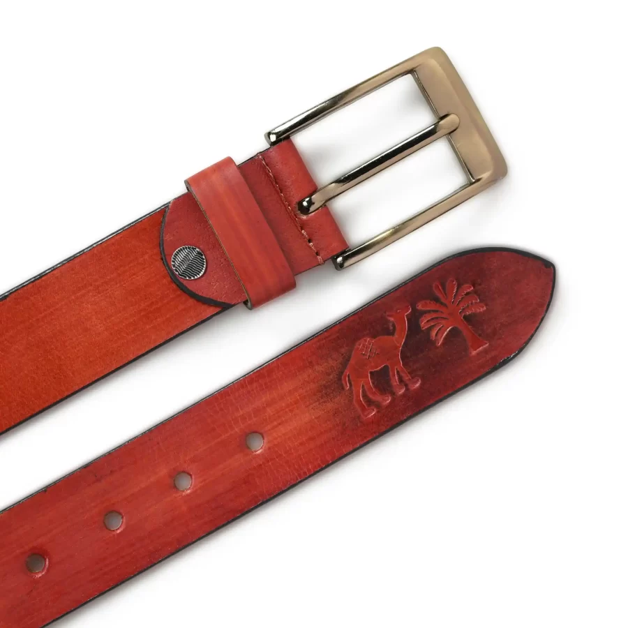 Front and backside of rusty red leather belt.