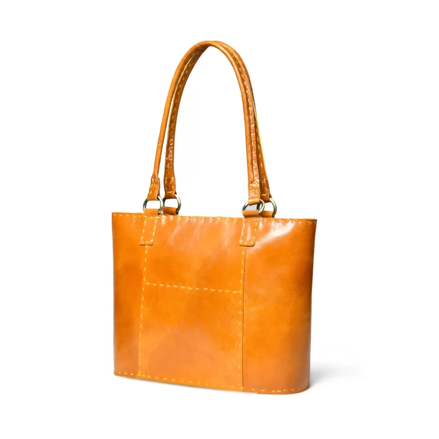 Side panel view of a mustard yellow leather tote bag 2