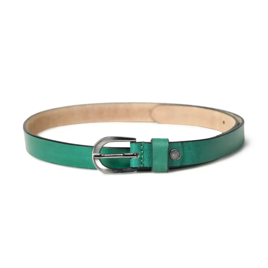 Close-up of the sliver buckle on a light green leather belt